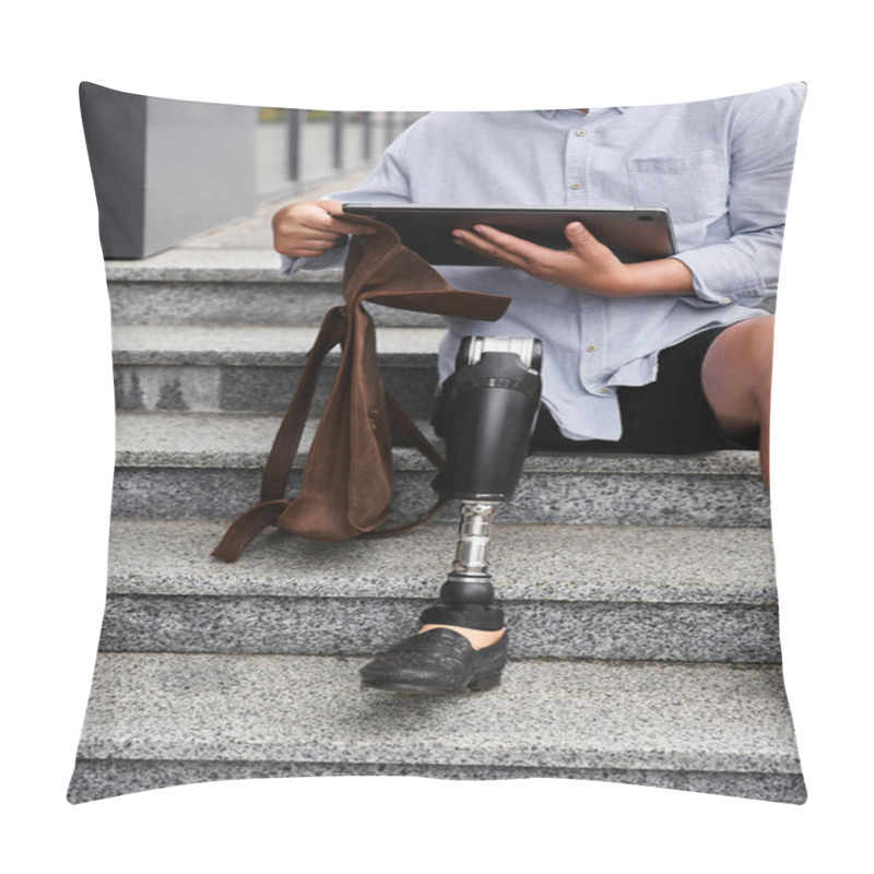 Personality  A Young Man With A Prosthetic Leg Sits On Stone Stairs While Using A Tablet And Holding A Bag. Pillow Covers