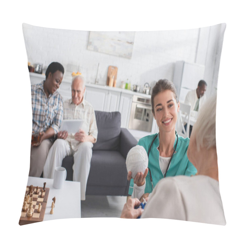 Personality  Smiling Nurse Holding Yarn Near Patient In Nursing Home  Pillow Covers