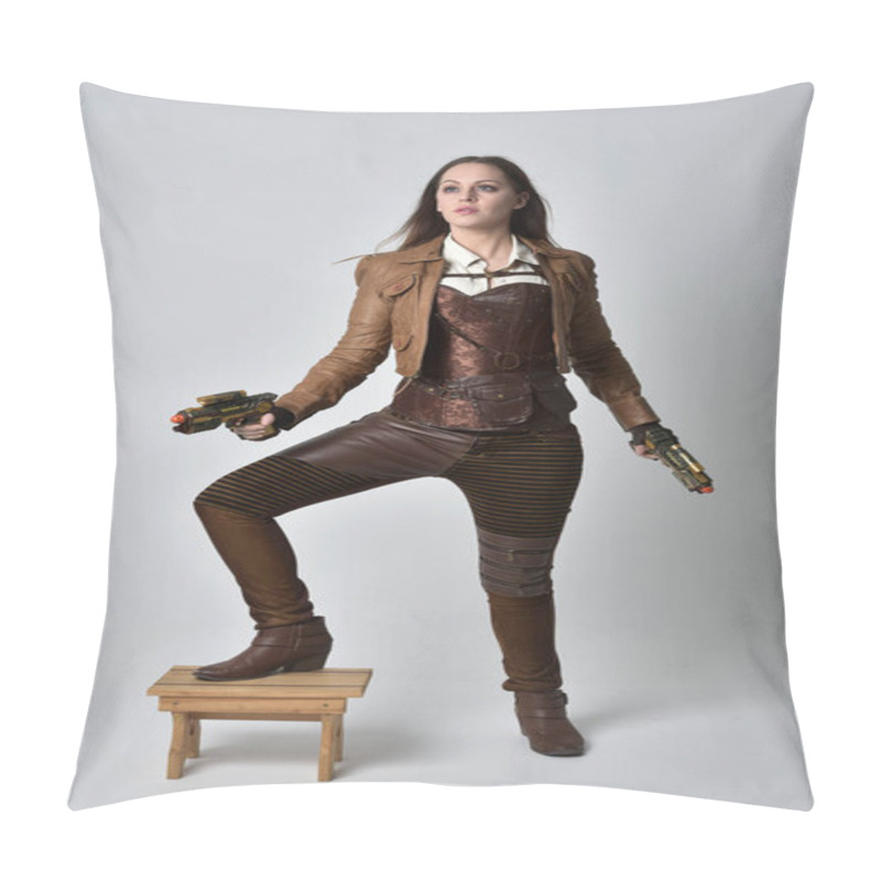 Personality  Full Length Portrait Of Brunette  Girl Wearing Brown Leather Steampunk Outfit. Standing Pose Holding A Gun, On Grey Studio Background. Pillow Covers