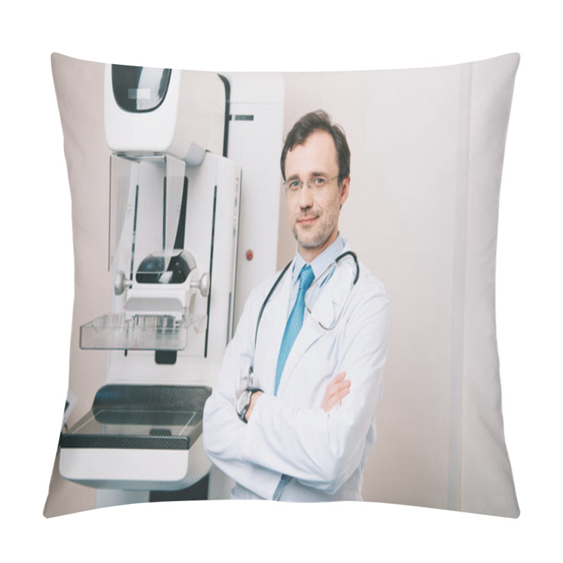 Personality  Smiling Doctor Standing With Crossed Arms Near X-ray Machine And Looking At Camera Pillow Covers