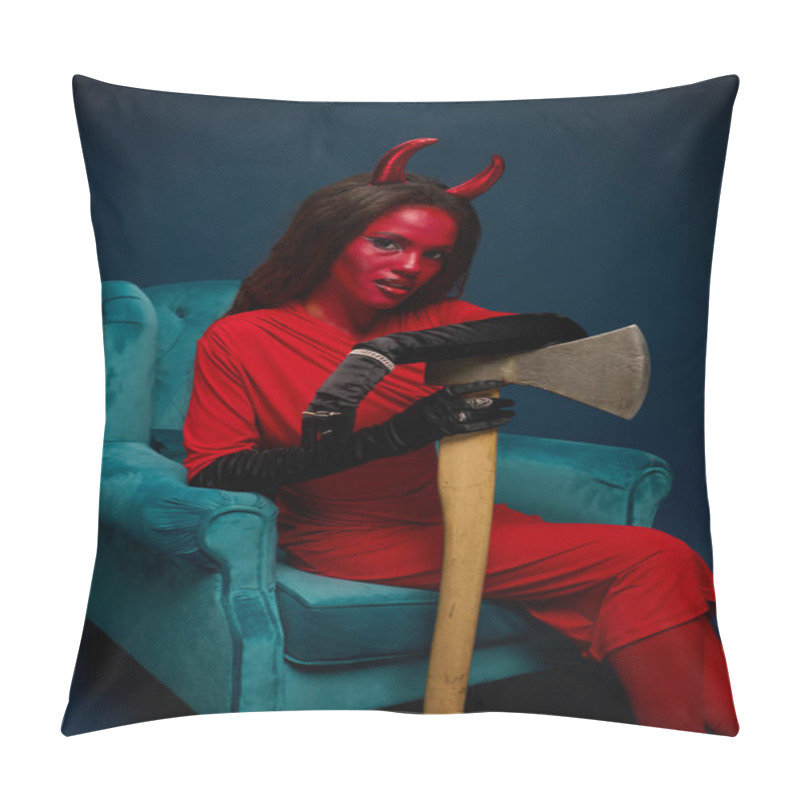 Personality  A Captivating Woman Dressed As A Devil Lounges In A Plush Blue Chair, Holding An Axe. Pillow Covers