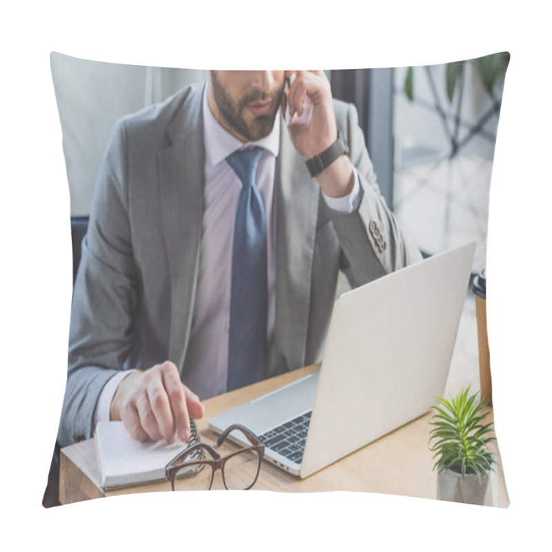 Personality  Cropped Shot Of Businessman Talking By Smartphone And Using Laptop In Office Pillow Covers