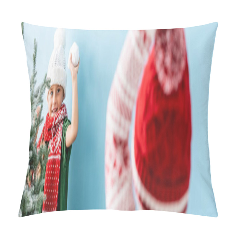 Personality  Selective Focus Of Kid In Hat And Scarf Holding Snowball While Playing With Brother On Blue, Panoramic Shot  Pillow Covers