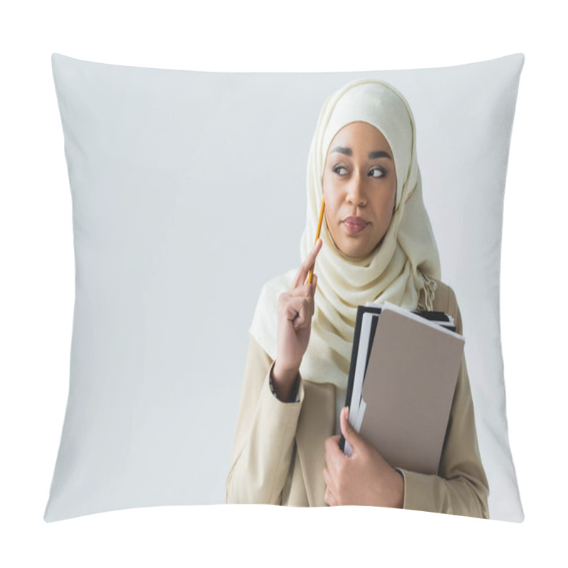 Personality  Pensive Muslim Woman In Hijab Holding Pencil And Folders Isolated On Grey Pillow Covers