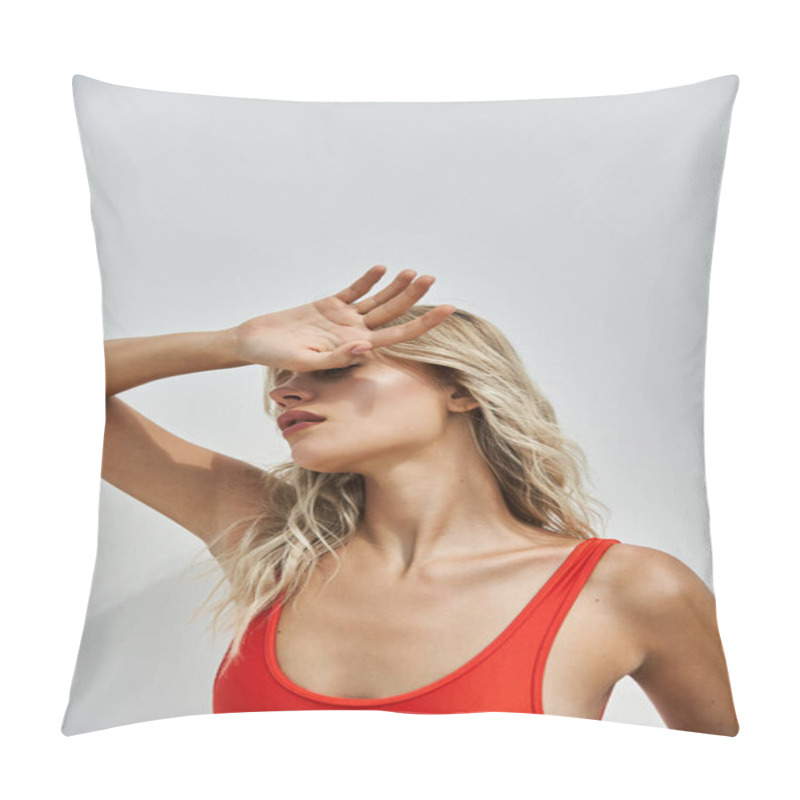 Personality  A Young Blonde Woman In An Orange Swimsuit Poses Against A Grey Background, Her Hand Shading Her Eyes From The Sun. Pillow Covers