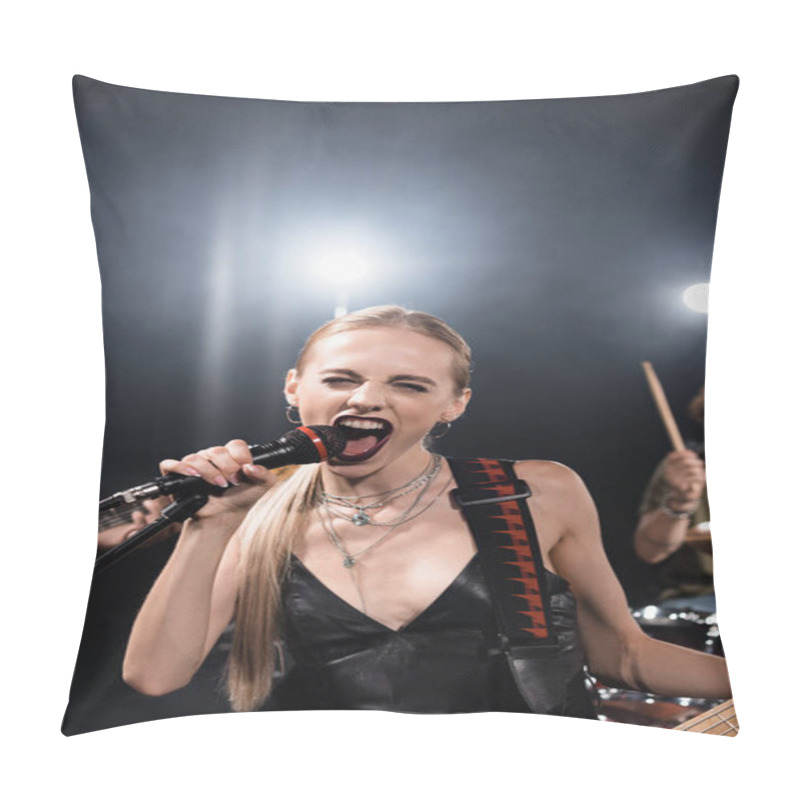 Personality  Blonde Woman With Bass Guitar Screaming In Microphone With Backlit And Blurred Musicians On Background Pillow Covers