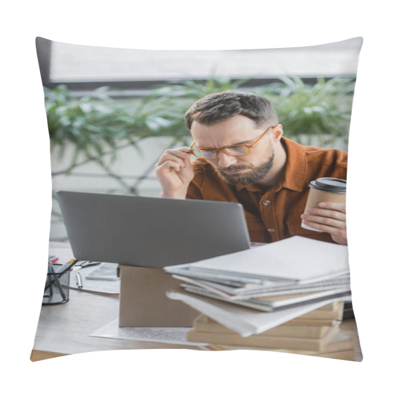 Personality  Serious Bearded Businessman With Paper Cup Adjusting Eyeglasses And Thinking Near Laptop On Carton Box, Smartphone, Pile Of Books And Notebooks And Pen Holder With Stationery On Desk In Office Pillow Covers