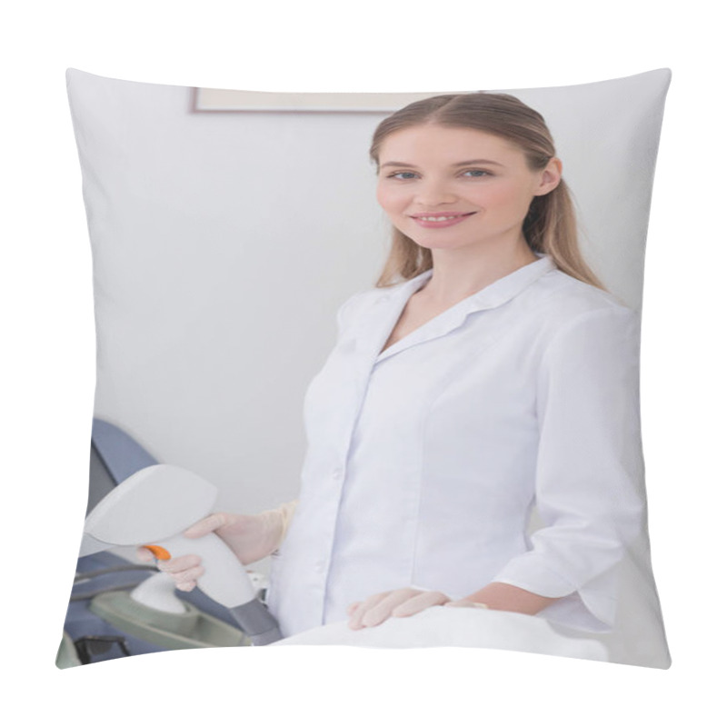 Personality  Portrait Of Smiling Cosmetologist In White Coat With Laser Hair Removal Apparatus In Salon Pillow Covers