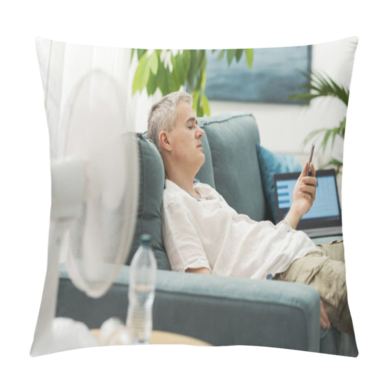 Personality  Exhausted Man Sitting On The Couch In The Living Room And Holding A Smartphone, He Is Suffering From The Heat Pillow Covers