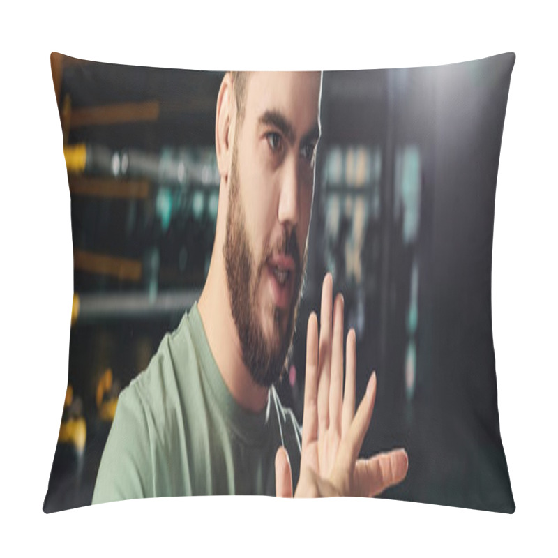 Personality  A Man In A Green Shirt Actively Gestures, Demonstrating A Hand Sign In A Self-defense Training Session. Pillow Covers