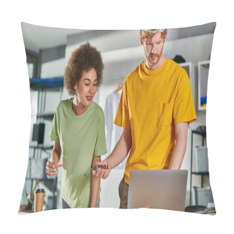 Personality  Smiling Young African American Craftswoman Holding Printing Layer While Working With Colleague Using Laptop And Clothes In Print Studio At Background, Start-up Innovation Concept Pillow Covers