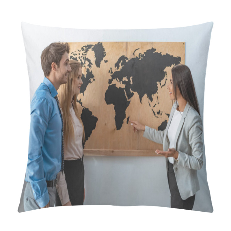 Personality  Smiling Travel Agent Pointing With Finger At Map On Wall Near Couple Of Tourists Pillow Covers