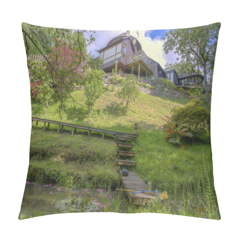 Personality  A Low Down Perspective Of A Green Downhill Meadow On A Bright Sunny Day, There Is A Small Stream Of Water Flowing At The Bottom Of The Meadow And A Wooden Walkway Leading From The Modern House Down Over The Stream Of Water.  Pillow Covers