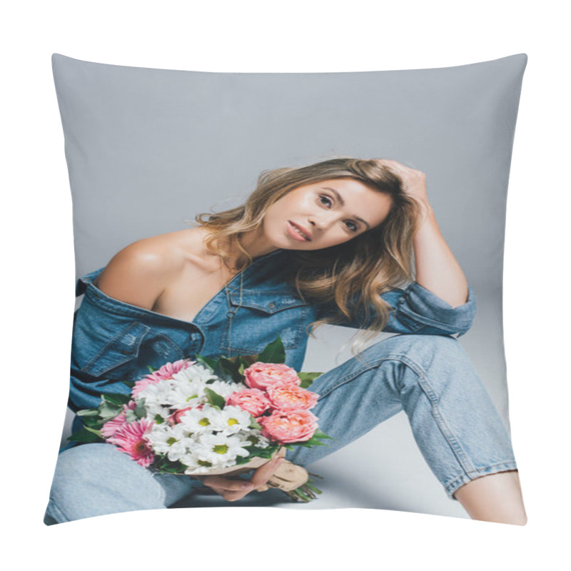 Personality  Sensual Young Woman In Denim Clothes Touching Hair While Sitting With Flowers On Grey Pillow Covers