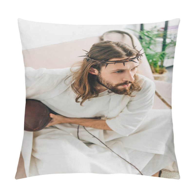 Personality  High Angle View Of Focused Jesus In Crown Of Thorns Holding Ball And Watching American Football On Sofa At Home Pillow Covers