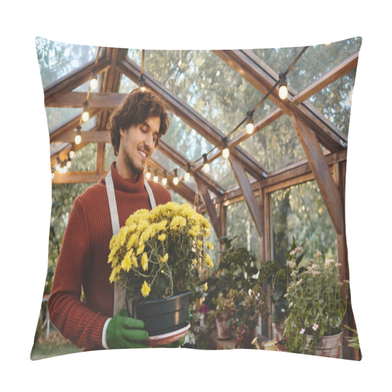 Personality  A Young And Handsome Man Engages In Gardening By Holding A Pot Of Bright Yellow Flowers Inside A Charming Greenhouse. The Warm Atmosphere Is Created By Soft Lights And Lush Plants All Around. Pillow Covers