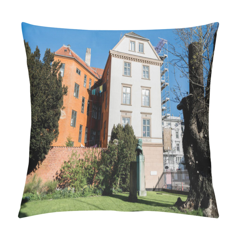 Personality  Sculpture Between Green Trees And Bushes, Brick Wall And Houses In Copenhagen, Denmark Pillow Covers