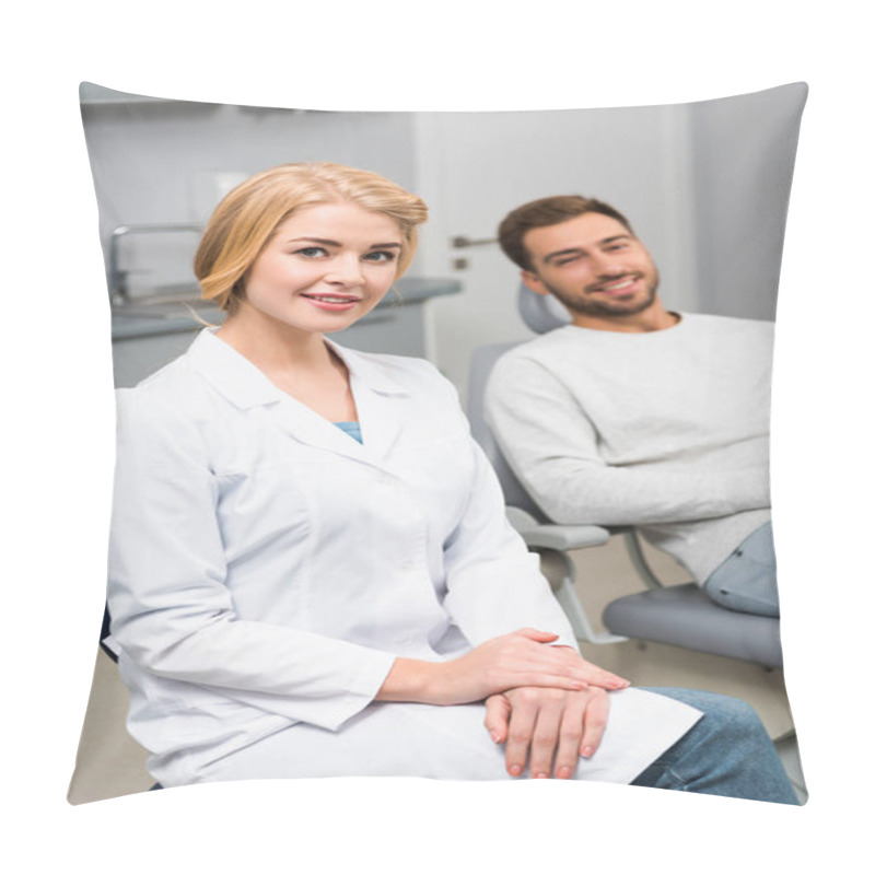 Personality  Happy Female Dentist And Handsome Young Client Looking At Camera In Dentist Office Pillow Covers