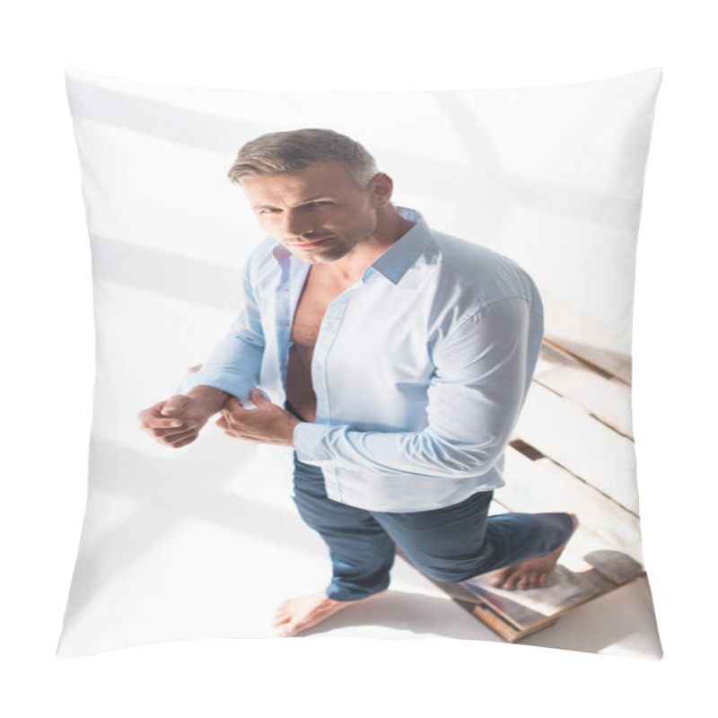 Personality  High Angle View Of Handsome Adult Man Buttoning Shirt And Looking At Camera On White Pillow Covers