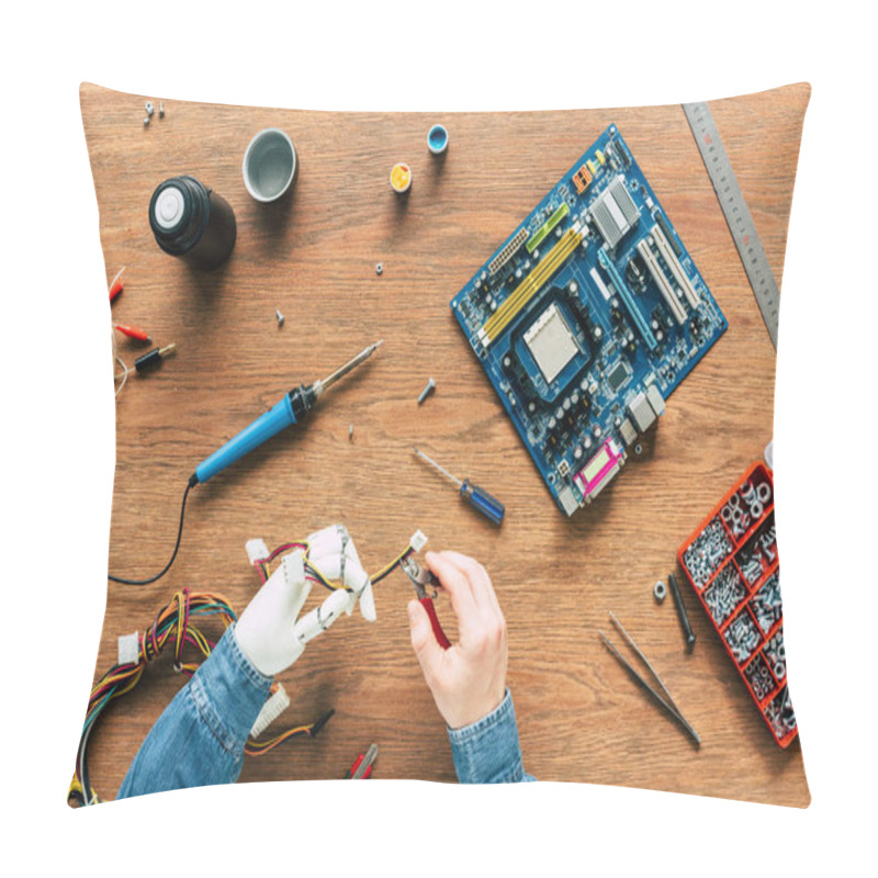 Personality  Cropped Image Of Man With Robotic Hand Cutting Wires By Nippers Over Table  Pillow Covers