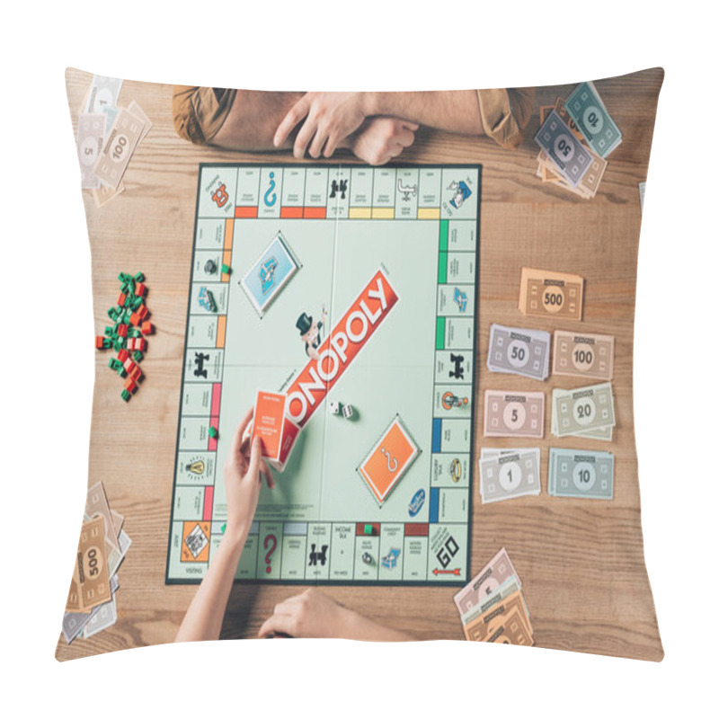 Personality  KYIV, UKRAINE - NOVEMBER 15, 2019: Cropped View Of Woman Holding Cards While Playing With Man In Monopoly At Table Pillow Covers