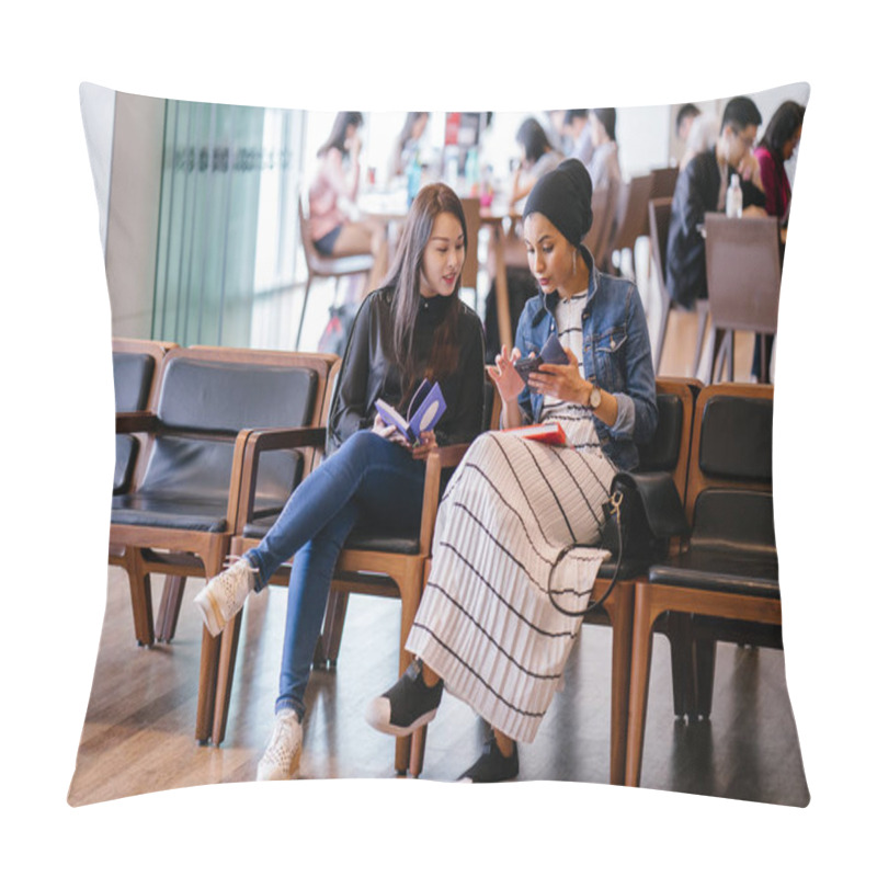 Personality  Two Young Female Friends Sitting On Bench And Reading Books And Discussing. One Is A Muslim Malay Woman And The Other A Chinese Woman.  Pillow Covers