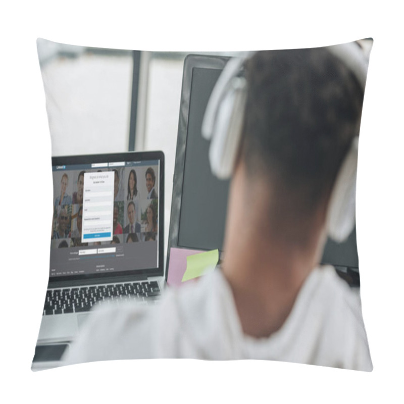 Personality  KYIV, UKRAINE - JULY 29, 2019: Back View Of African American Programmer In Headphones Sitting Near Laptop With Linkedin Website On Screen Pillow Covers