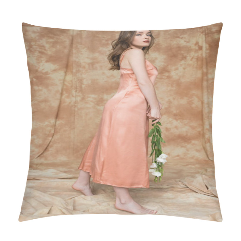 Personality  Full Length Of Barefoot And Brunette And Young Woman In Pink Silk Slip Dress Holding White Flowers While Looking At Camera While Standing On Mottled Beige Background, Sensuality, Elegance  Pillow Covers