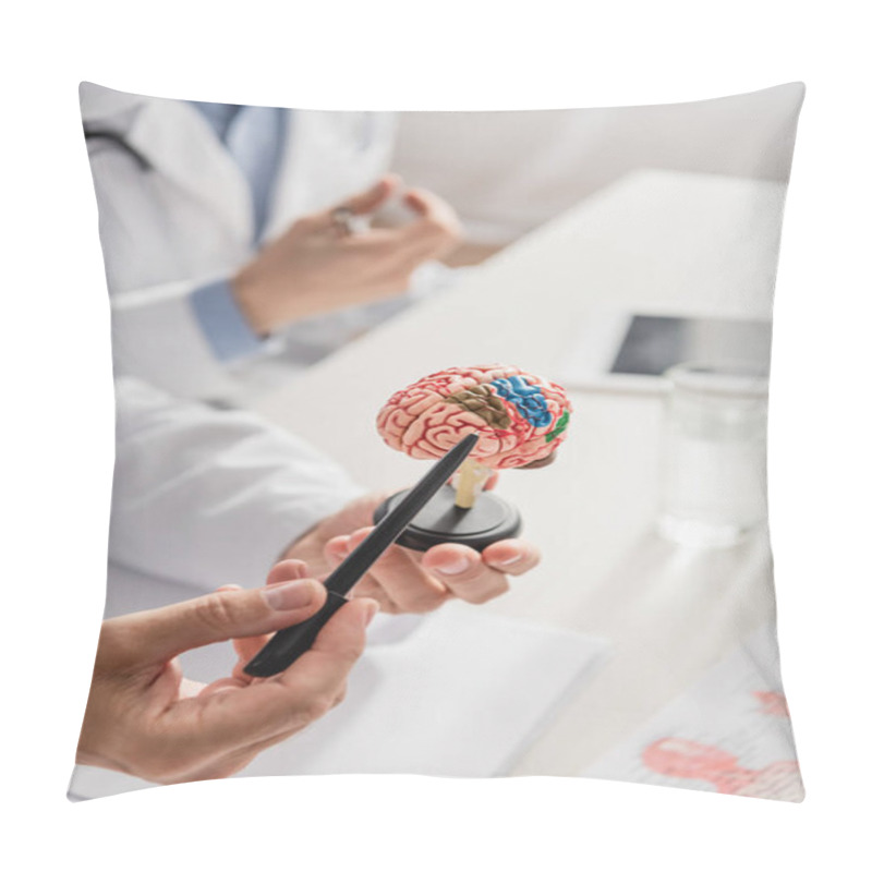 Personality  Cropped View Of Doctor Pointing With Pen At Brain Anatomical Model Near Colleague On Blurred Background Pillow Covers