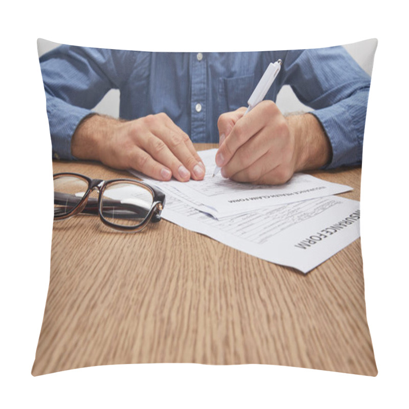 Personality  Cropped Shot Of Man Signing Insurance Form At Wooden Table Pillow Covers