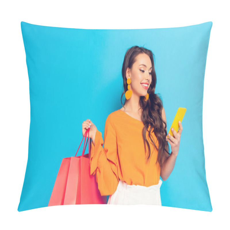 Personality  Cheerful Elegant Girl Holding Shopping Bags While Chatting On Smartphone On Blue Background Pillow Covers