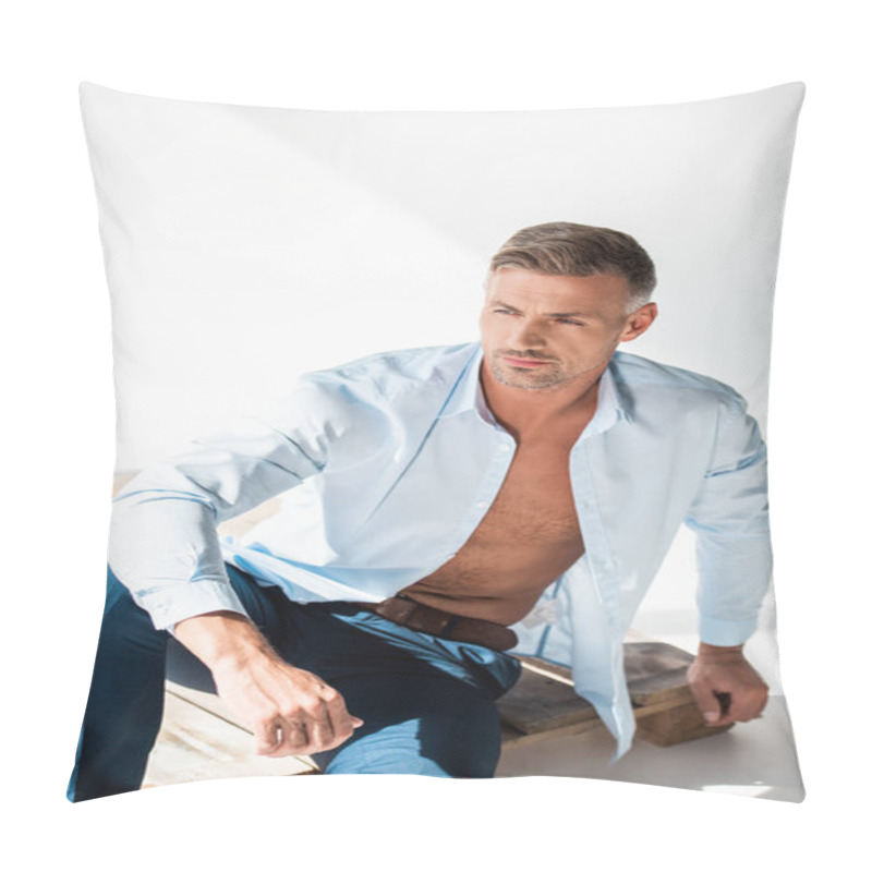 Personality  Attractive Adult Man In Unbuttoned Shirt Sitting On Wooden Pallet On White And Looking Away Pillow Covers