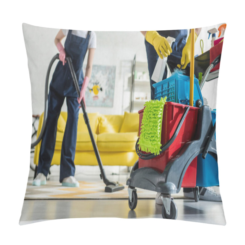 Personality  Cropped View Of Cleaner In Rubber Gloves Holding Spray Bottle Near Cleaning Trolley And Coworker With Vacuum Cleaner  Pillow Covers