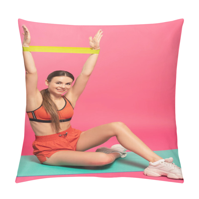 Personality  Happy Sportswoman Holding Resistance Band Above Head And Sitting On Pink  Pillow Covers