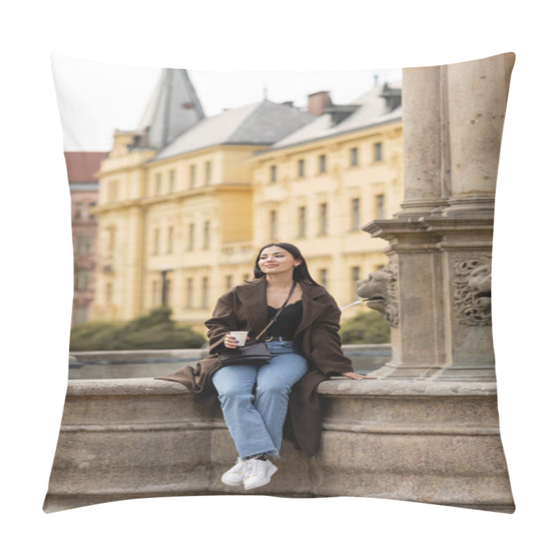 Personality  Smiling Woman In Coat Holding Paper Cup While Sitting On Ancient Fountain In Charles Square In Prague  Pillow Covers