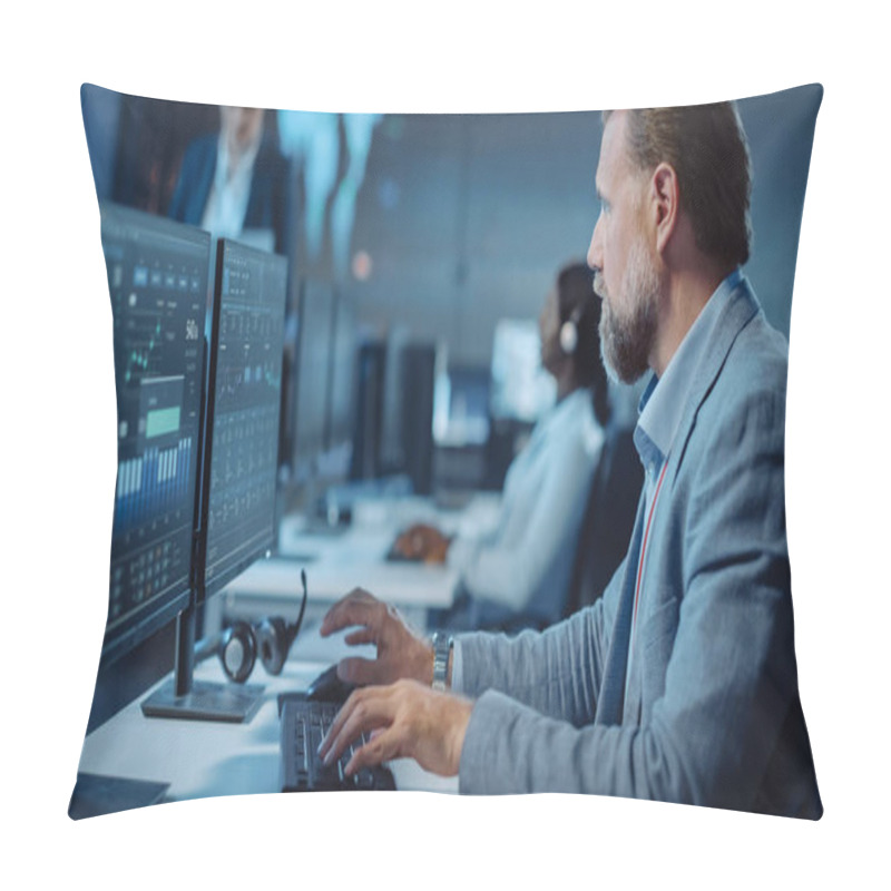 Personality  Portrait Of Serious Professional Technical Controller Sitting At His Desk With Multiple Computer Displays Before Him. In The Background His Colleagues Working In System Control And Monitoring Center. Pillow Covers