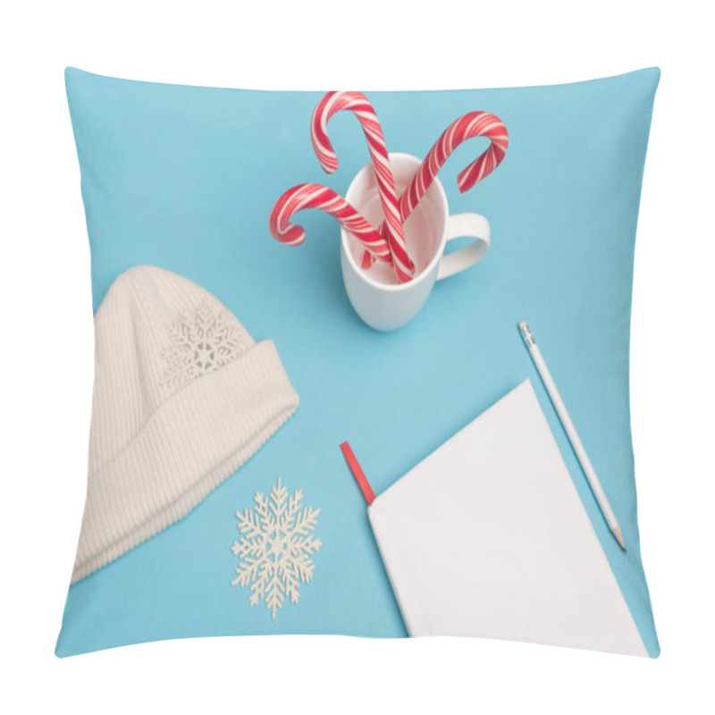 Personality  Top View Of Beanie, Candy Canes And Blank Notebook On Blue Background Pillow Covers