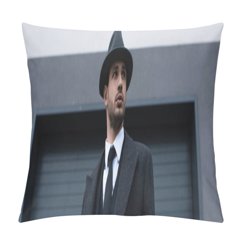 Personality  Low Angle View Of Mafioso In Black Coat And Hat With Weapon On Street, Panoramic Shot Pillow Covers