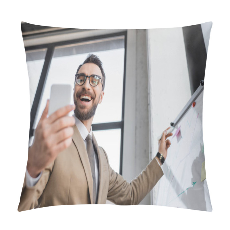 Personality  Low Angle View Of Successful And Overjoyed Businessman In Beige Blazer And Eyeglasses Standing With Marker Near Flip Chart And Looking At Mobile Phone On Blurred Foreground Pillow Covers