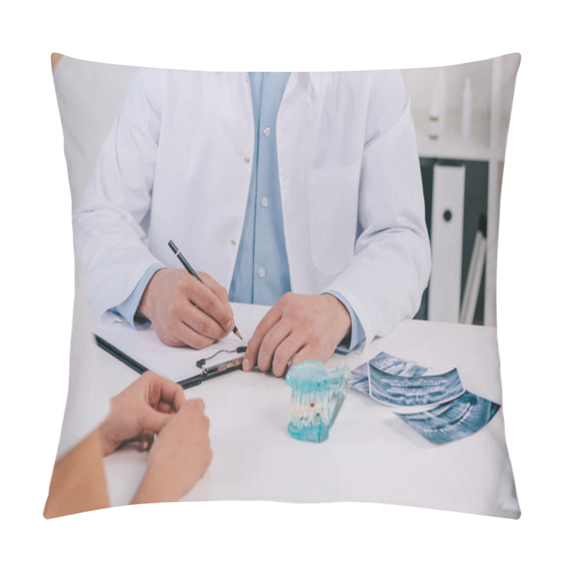 Personality  Cropped View Of Orthodontist Writing Diagnosis During Consultation With Woman In Clinic Pillow Covers