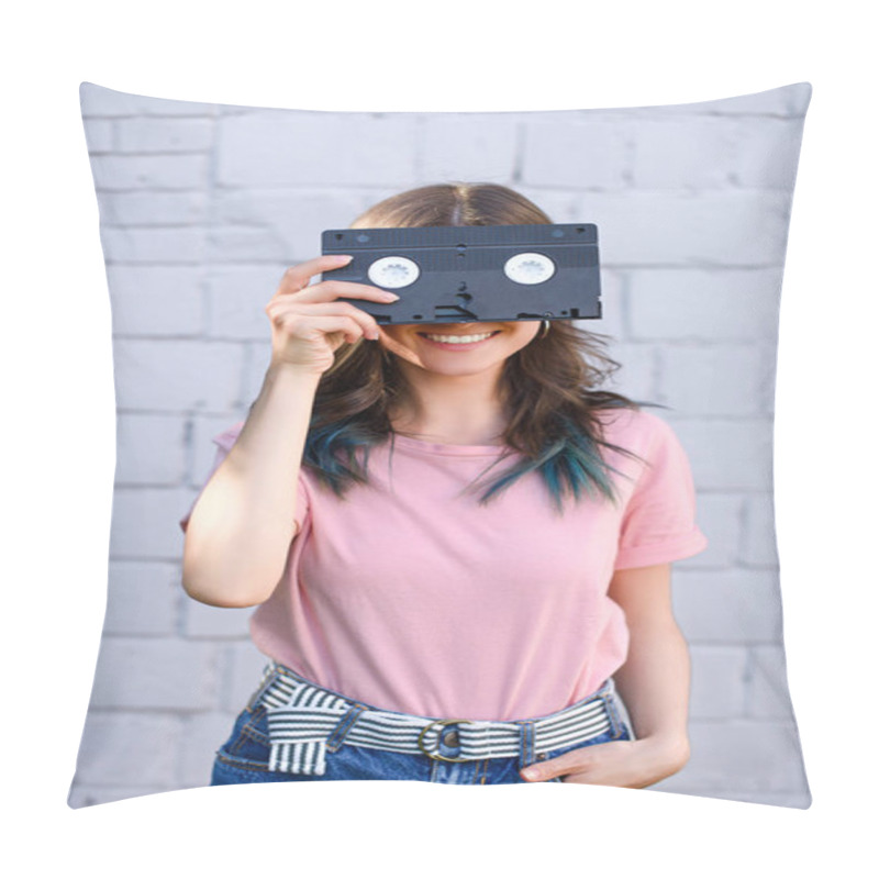 Personality  Obscured View Of Smiling Woman Covering Eyes With Retro Video Cassette In Hand Against White Brick Wall Pillow Covers