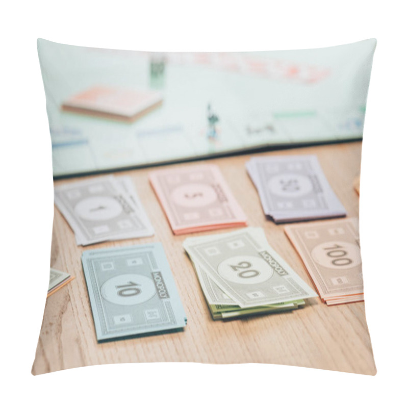 Personality  KYIV, UKRAINE - NOVEMBER 15, 2019: Selective Focus Of Toy Currency With Monopoly Game On Wooden Table Pillow Covers