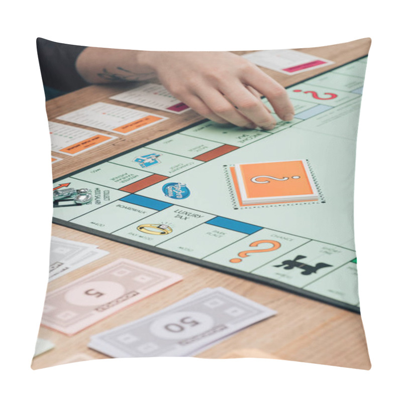 Personality  KYIV, UKRAINE - NOVEMBER 15, 2019: Cropped View Of Woman Playing Monopoly Game At Wooden Table Pillow Covers