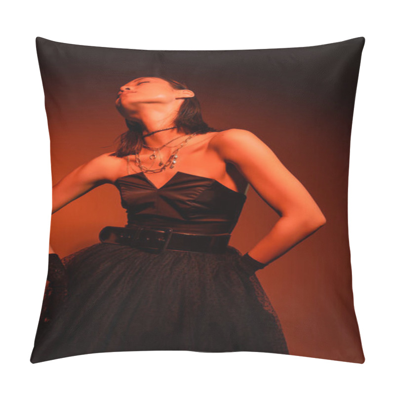 Personality  Stylish Asian Woman With Closed Eyes And Wet Hairstyle Posing In Black Strapless Dress With Tulle Skirt And Gloves While Standing On Orange Background With Red Lighting, Golden Jewelry, Young Model Pillow Covers