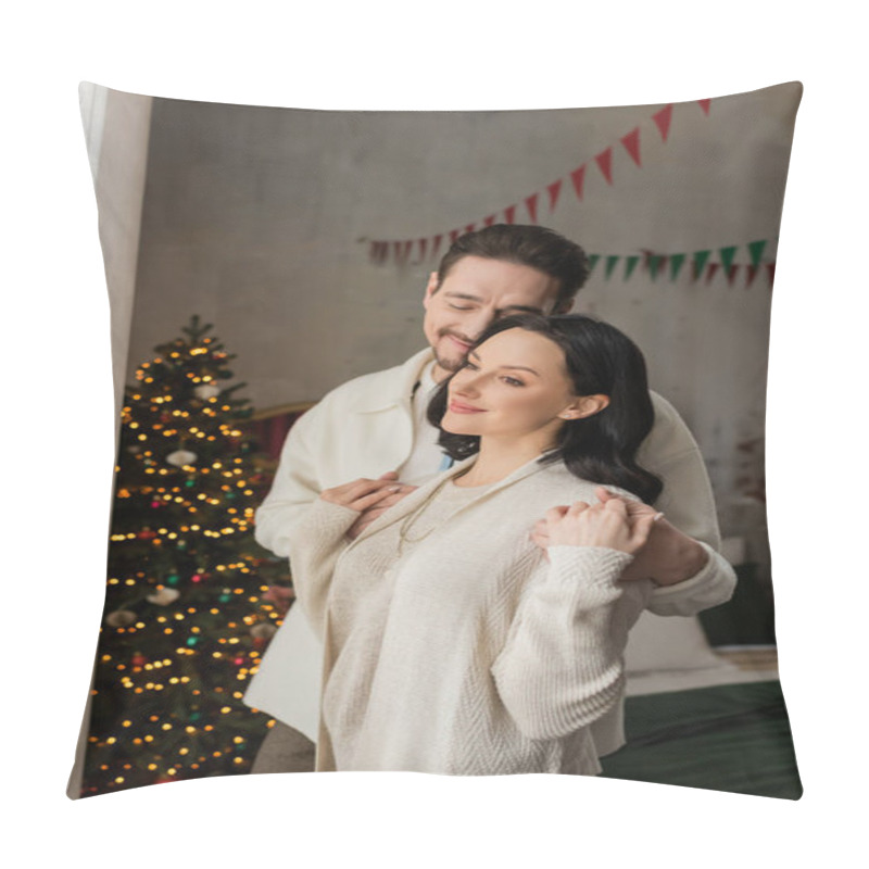 Personality  Joyful Man With Closed Eyes Hugging Happy Wife In Cozy Home Wear Near Blurred Christmas Tree Pillow Covers