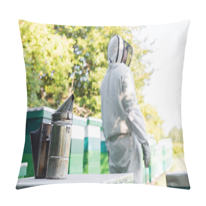 Personality  Selective Focus Of Bee Smoker Near Beehives And Blurred Beekeeper In Protective Suit Pillow Covers