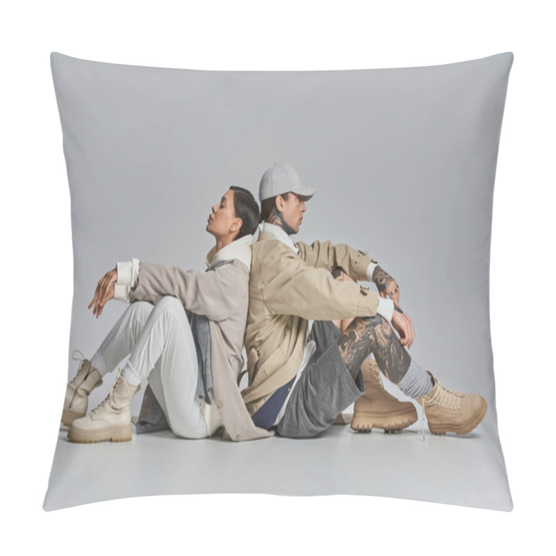 Personality  A Young Stylish Man And Woman In A Trench Coats Sitting Comfortably On The Ground In An Urban Setting. Pillow Covers