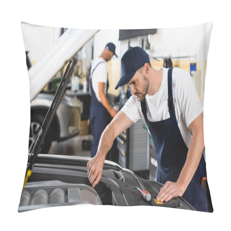 Personality  Selective Focus Of Mechanic In Cap Repairing Car Near Coworker In Workshop  Pillow Covers