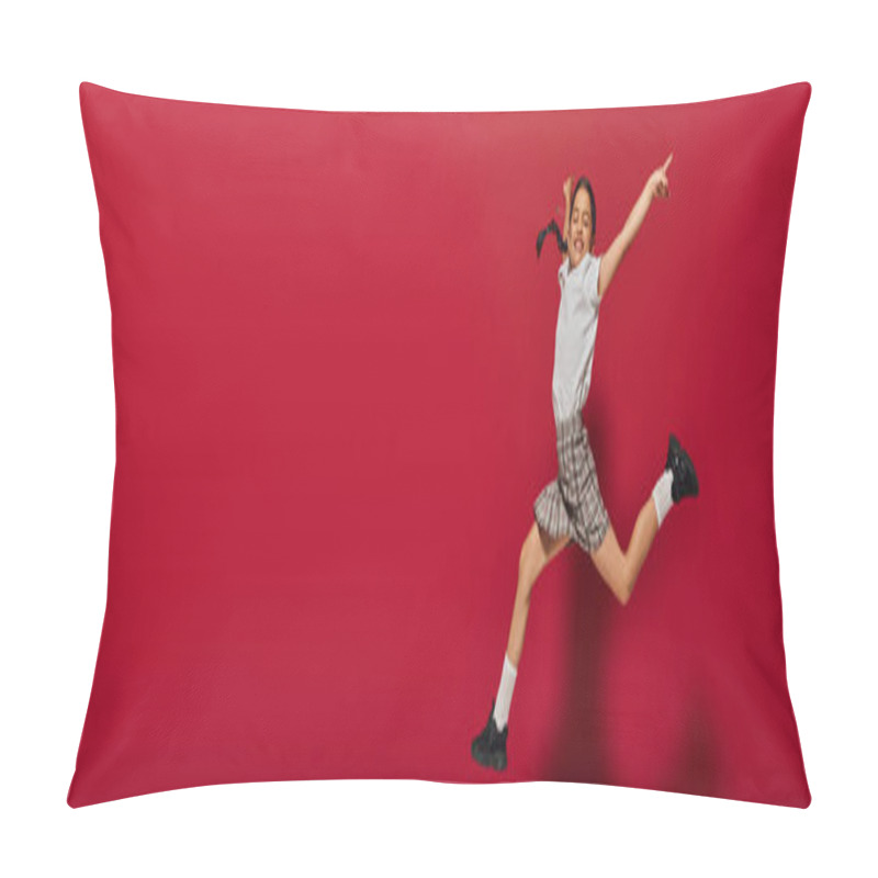 Personality  Positive And Stylish Preadolescent Girl In White T-shirt And Plaid Skirt Jumping And Pointing With Finger On Red Background, Hairstyle And Trendy Accessories Concept, Banner  Pillow Covers