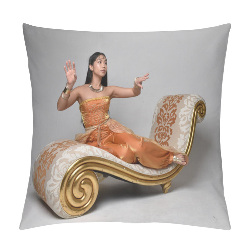 Personality  Full Length Portrait Of Pretty Young Asian Woman Wearing Golden Arabian Robes Like A Genie, Seated Pose On Lounge, Isolated On Studio Background. Pillow Covers